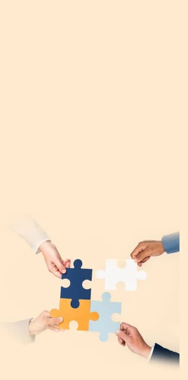 Four hands assembling colourful puzzle pieces