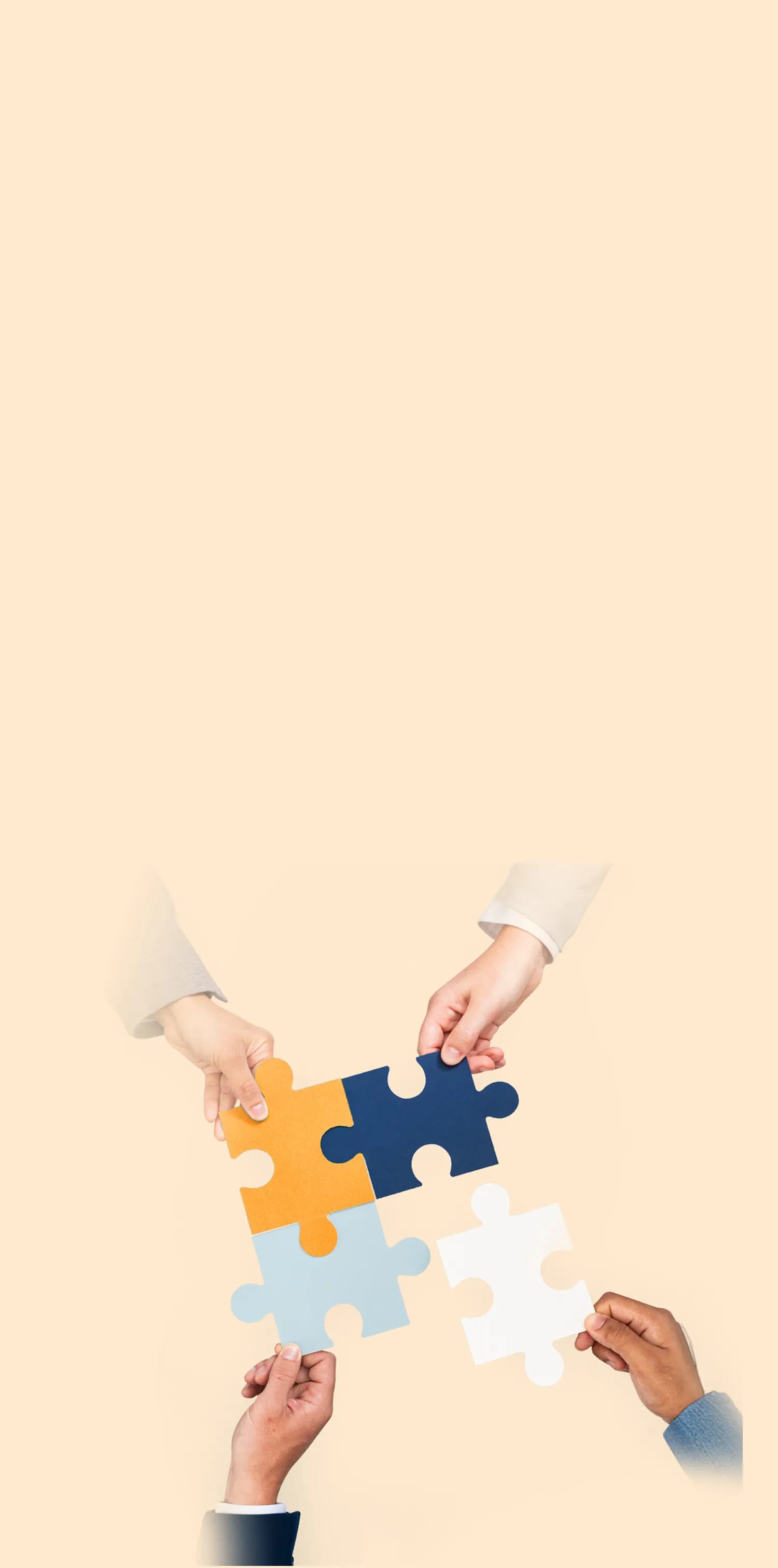 Four hands assembling colourful puzzle pieces